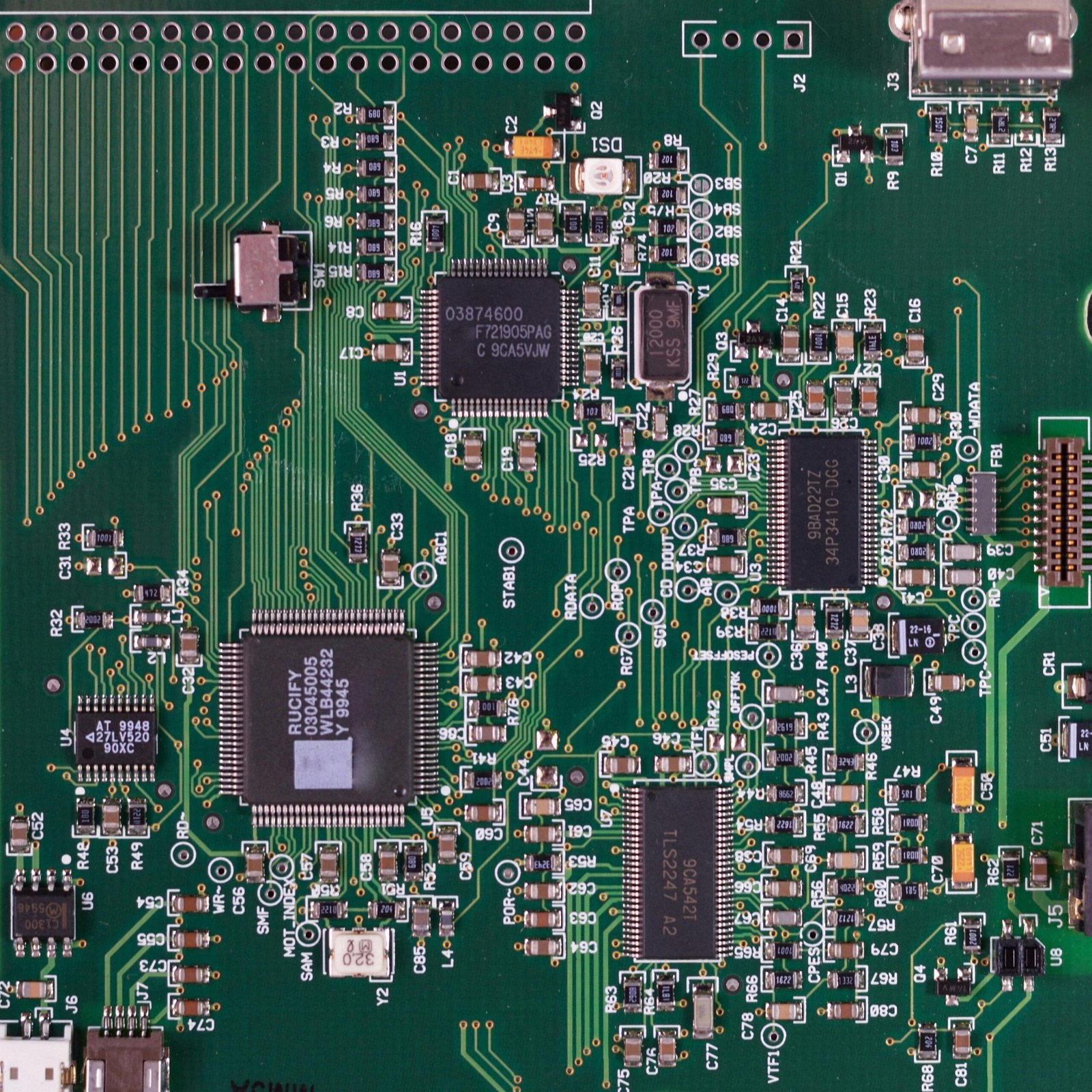 Detailed image of a green circuit board featuring various components and microprocessors.